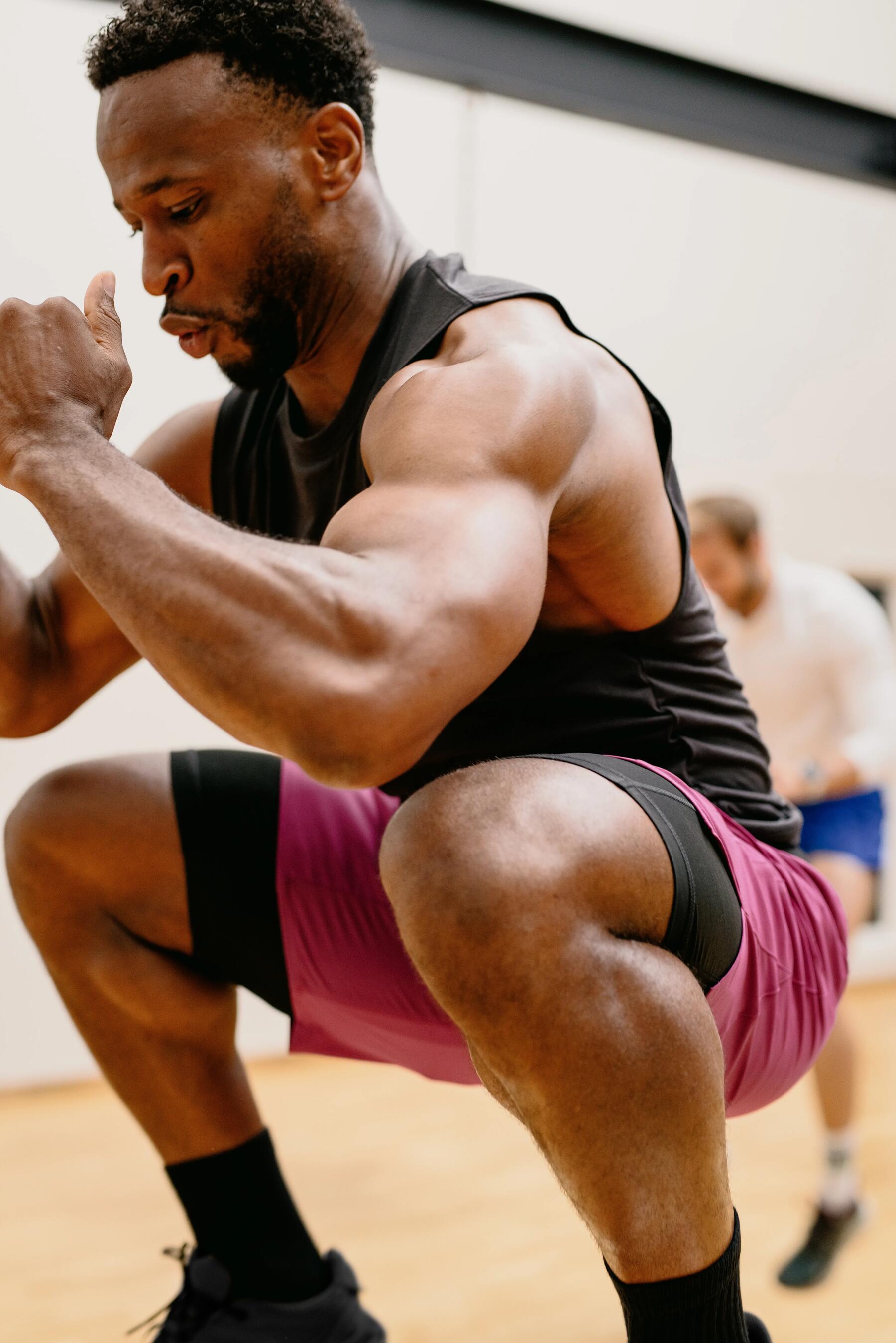 Two guys doing push ups outdoor on a wooden floor