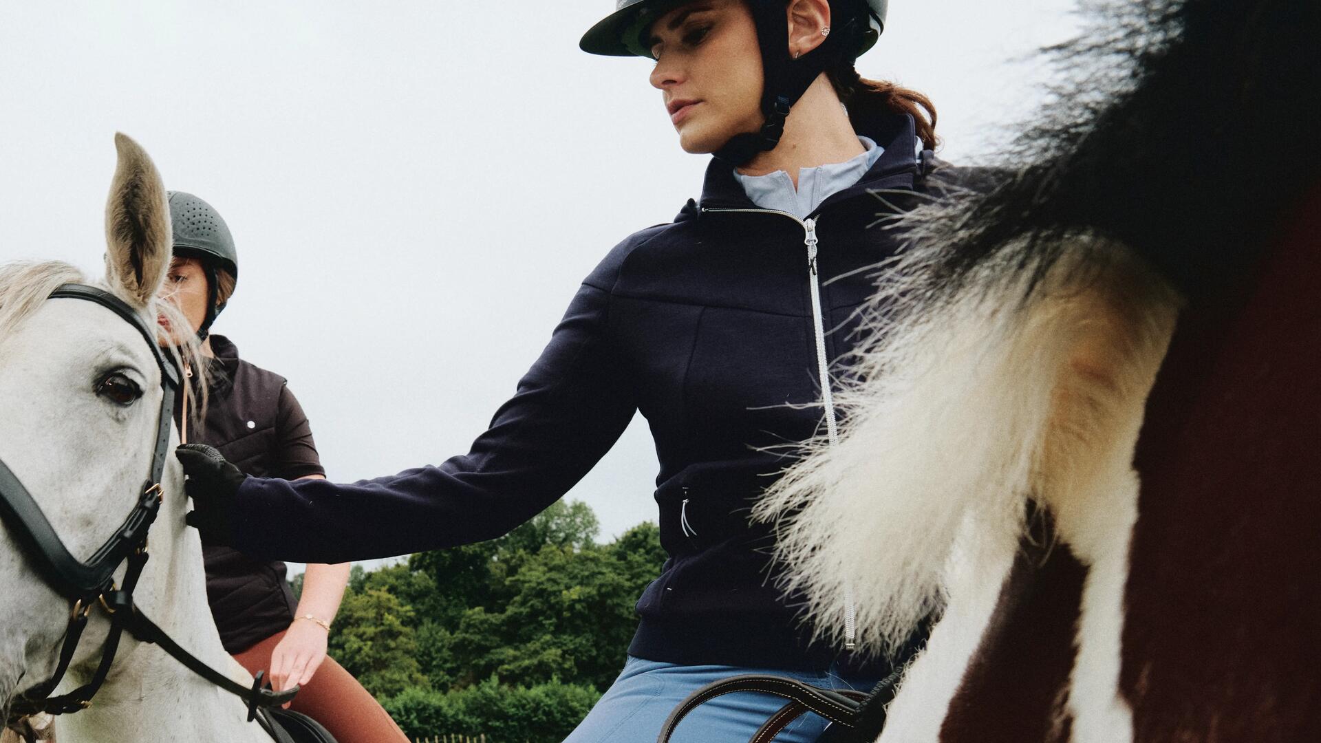 kid horseback riding in a field