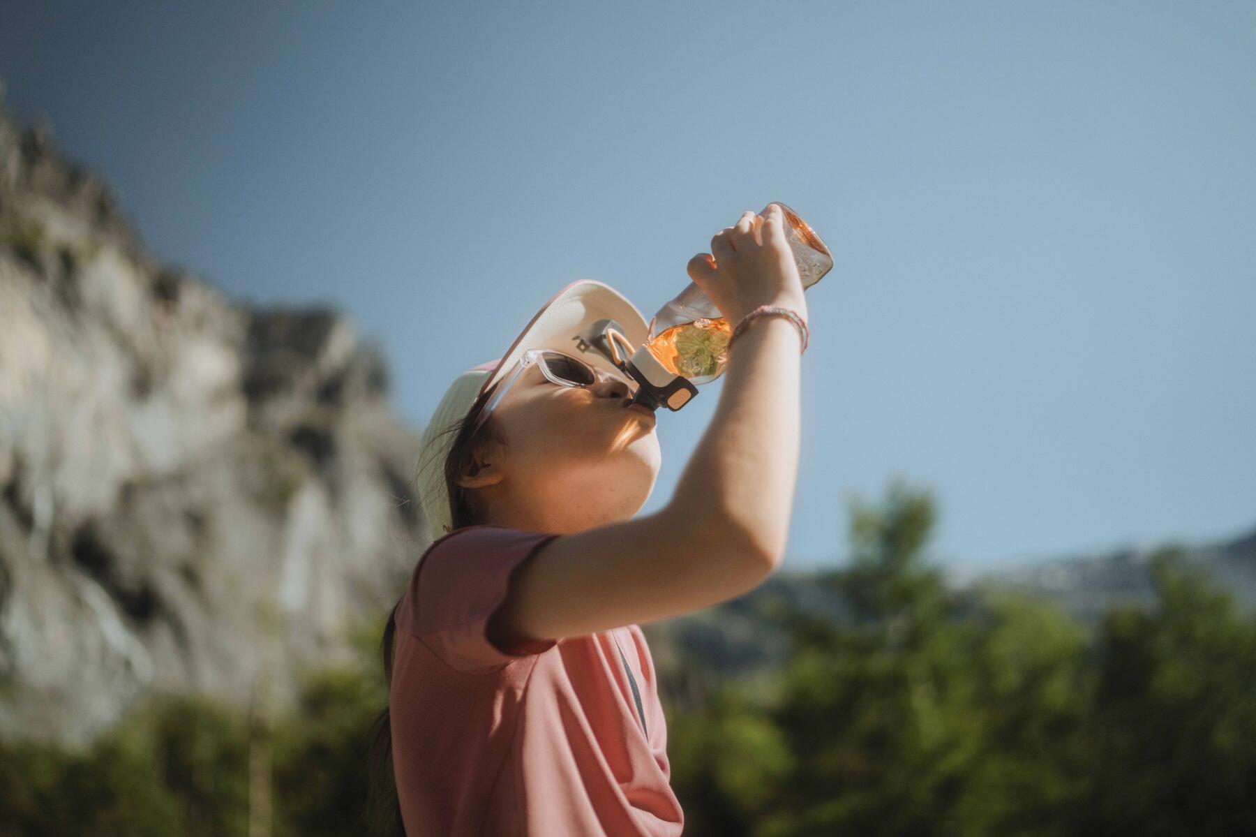 girl drinking water during a hike