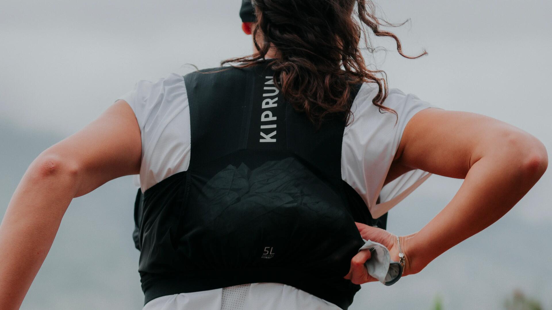 A woman preparing her hydration system before leaving home on her bike