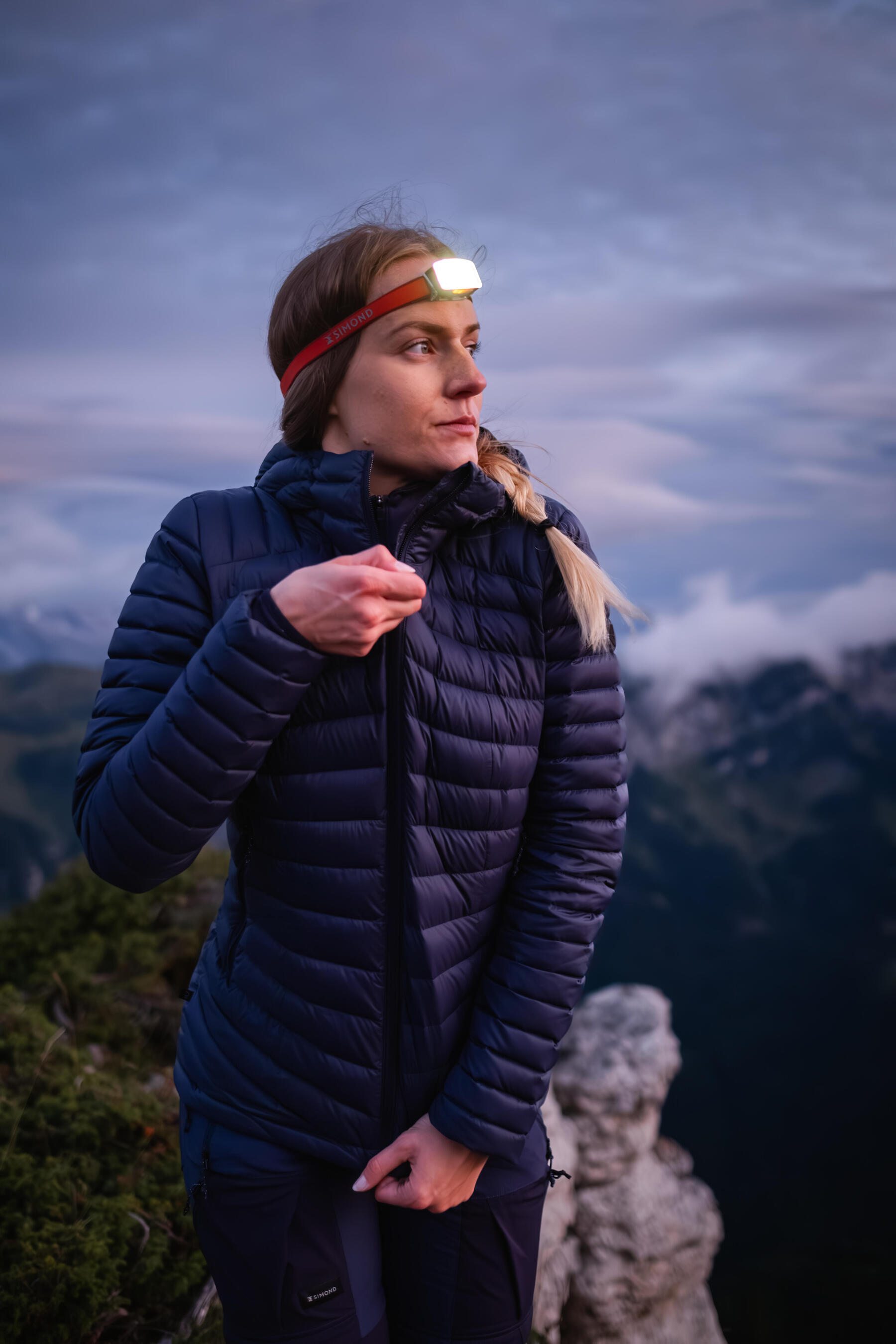 femme avec sa doudoune et sa lampe frontale