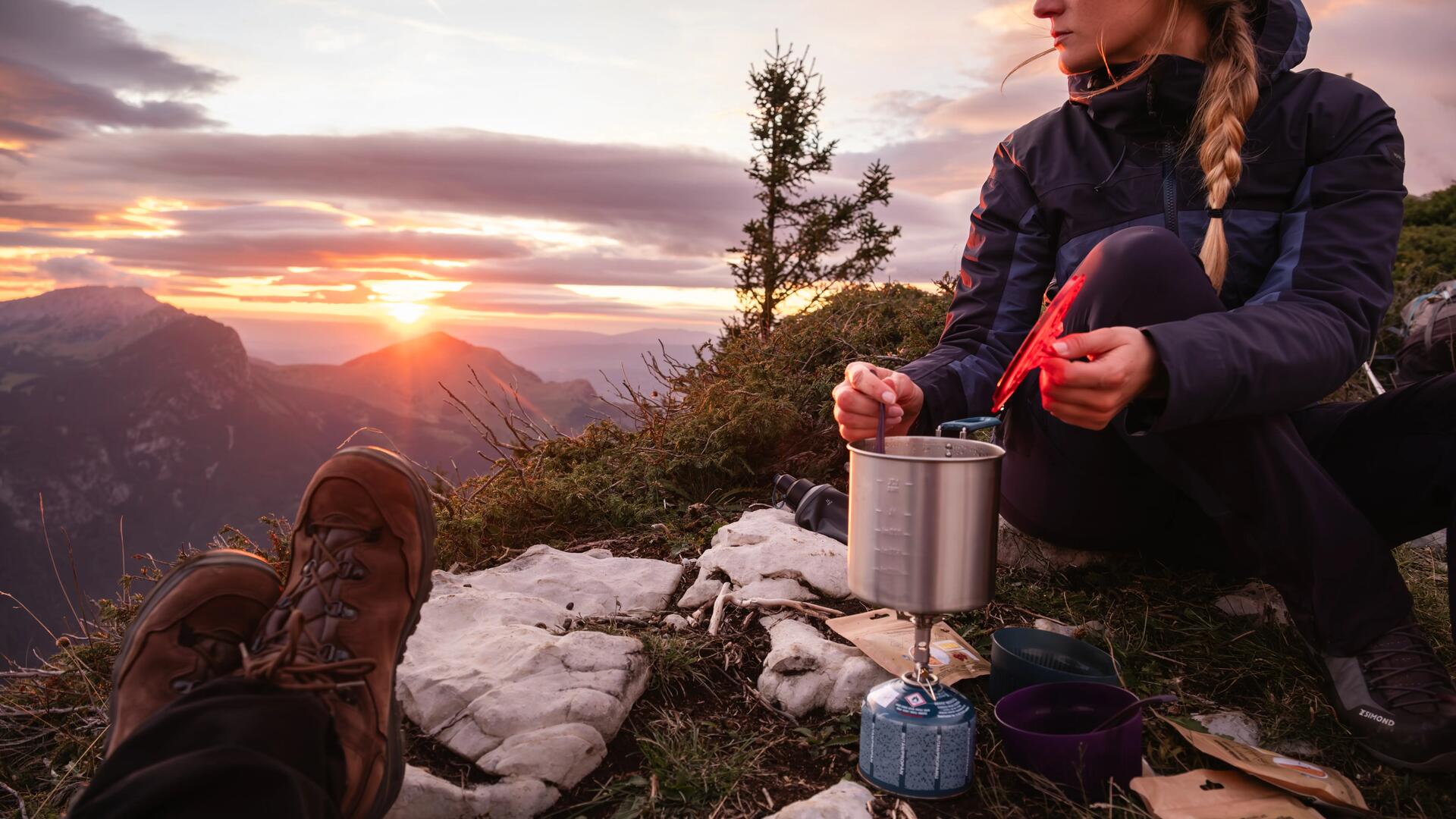 A smiling mother and son close their tent