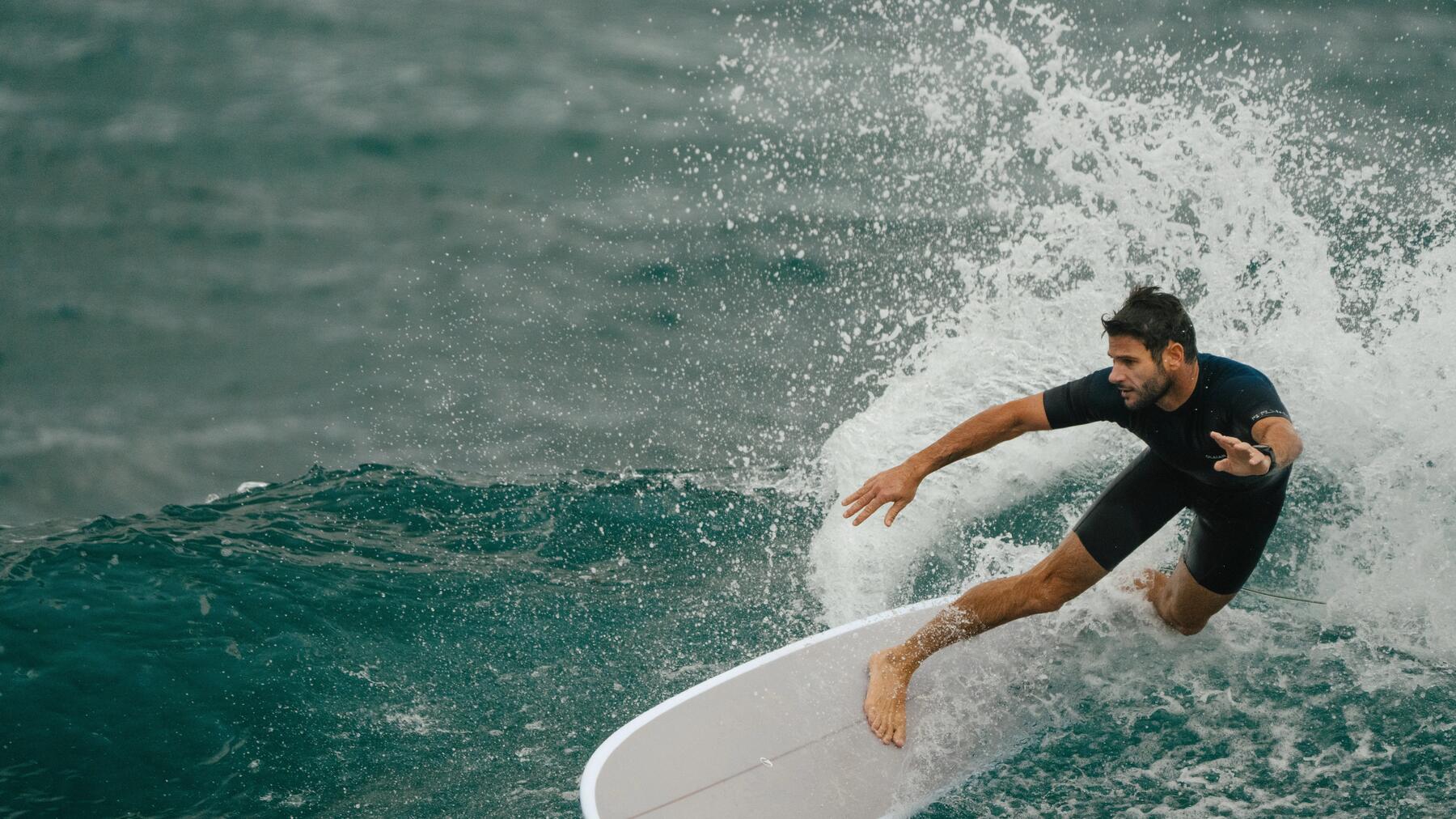 woman walking off the water with her surf board