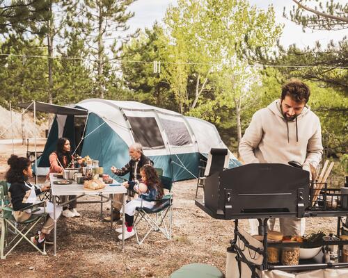 Two people set up their campsite in the Canadian Rockies