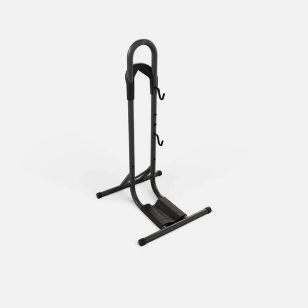 Black floor stand holding one bike upright