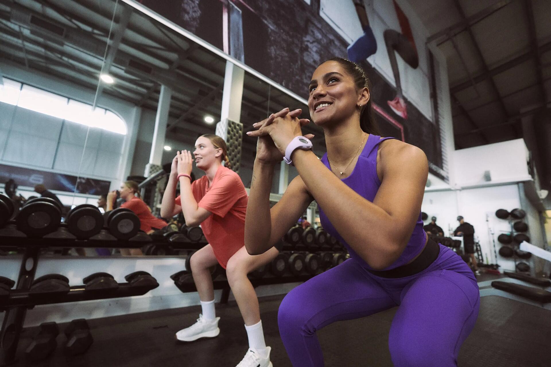 Two man working out with dumbbells in a gym