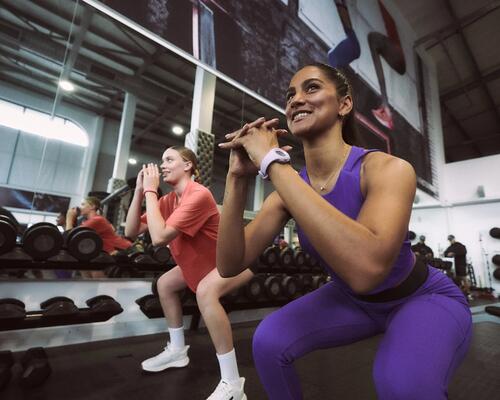 Two man working out with dumbbells in a gym