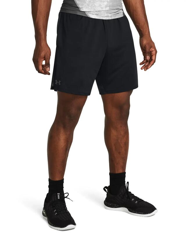 Mann trägt schwarze Sportschuhe und eine schwarze Sporthose mit grauem Bund und Logo.
