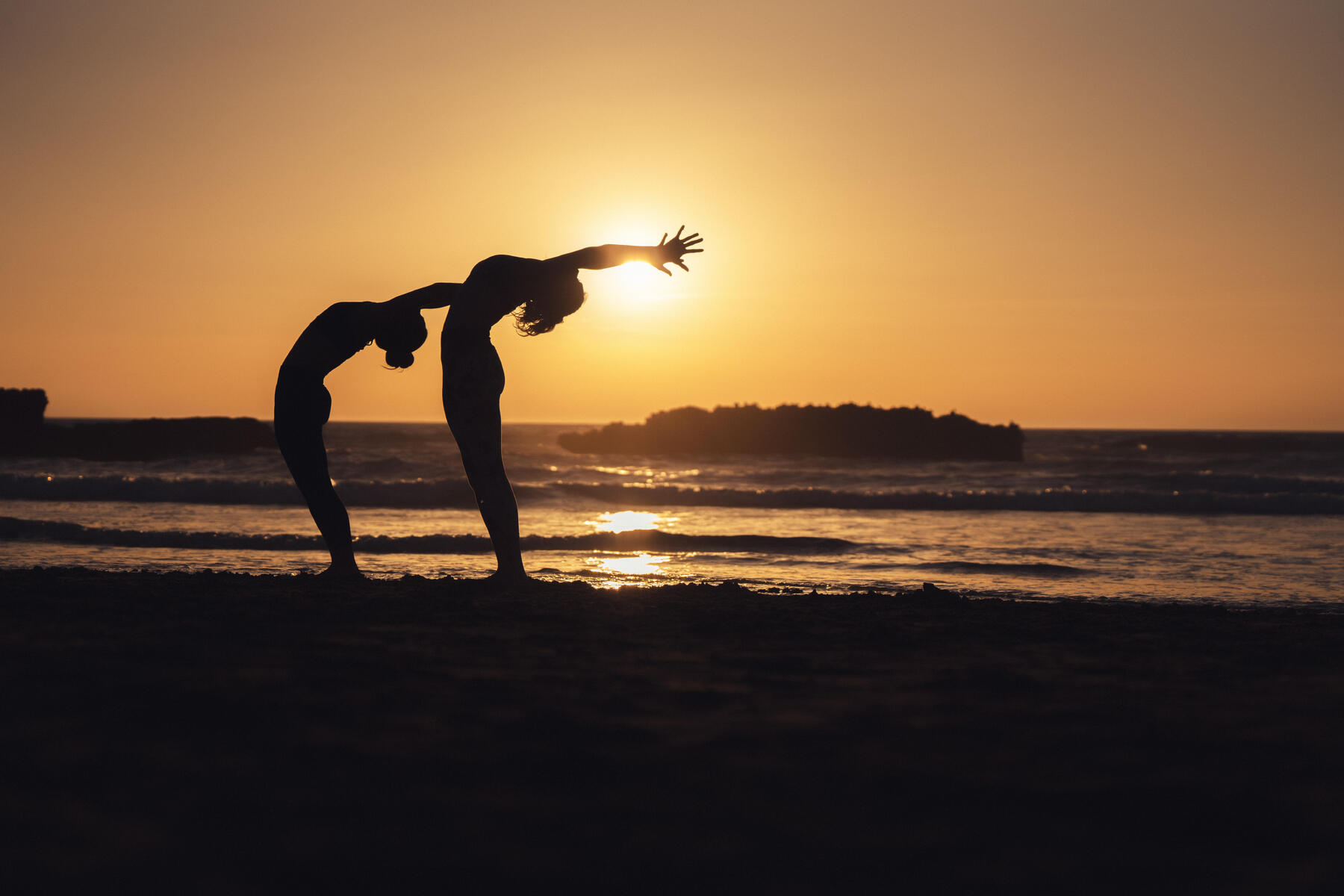 Kobiety ćwiczące pilates na plaży 
