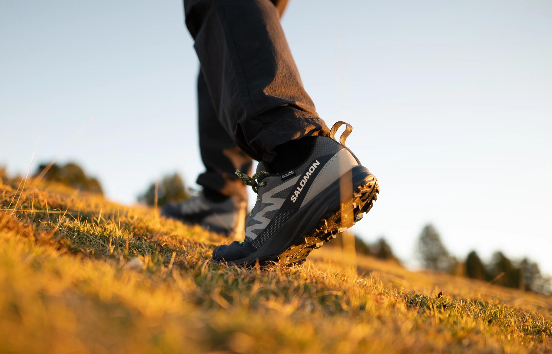 a woman tying her hiking shoes