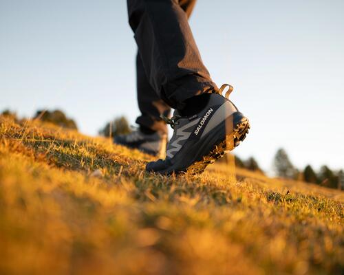 a woman tying her hiking shoes