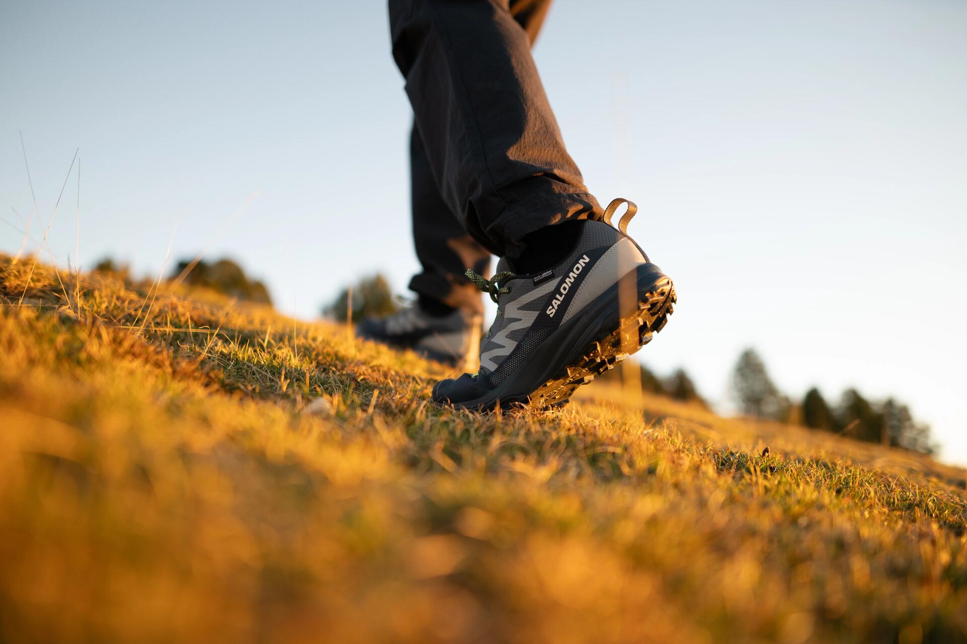 a woman tying her hiking shoes