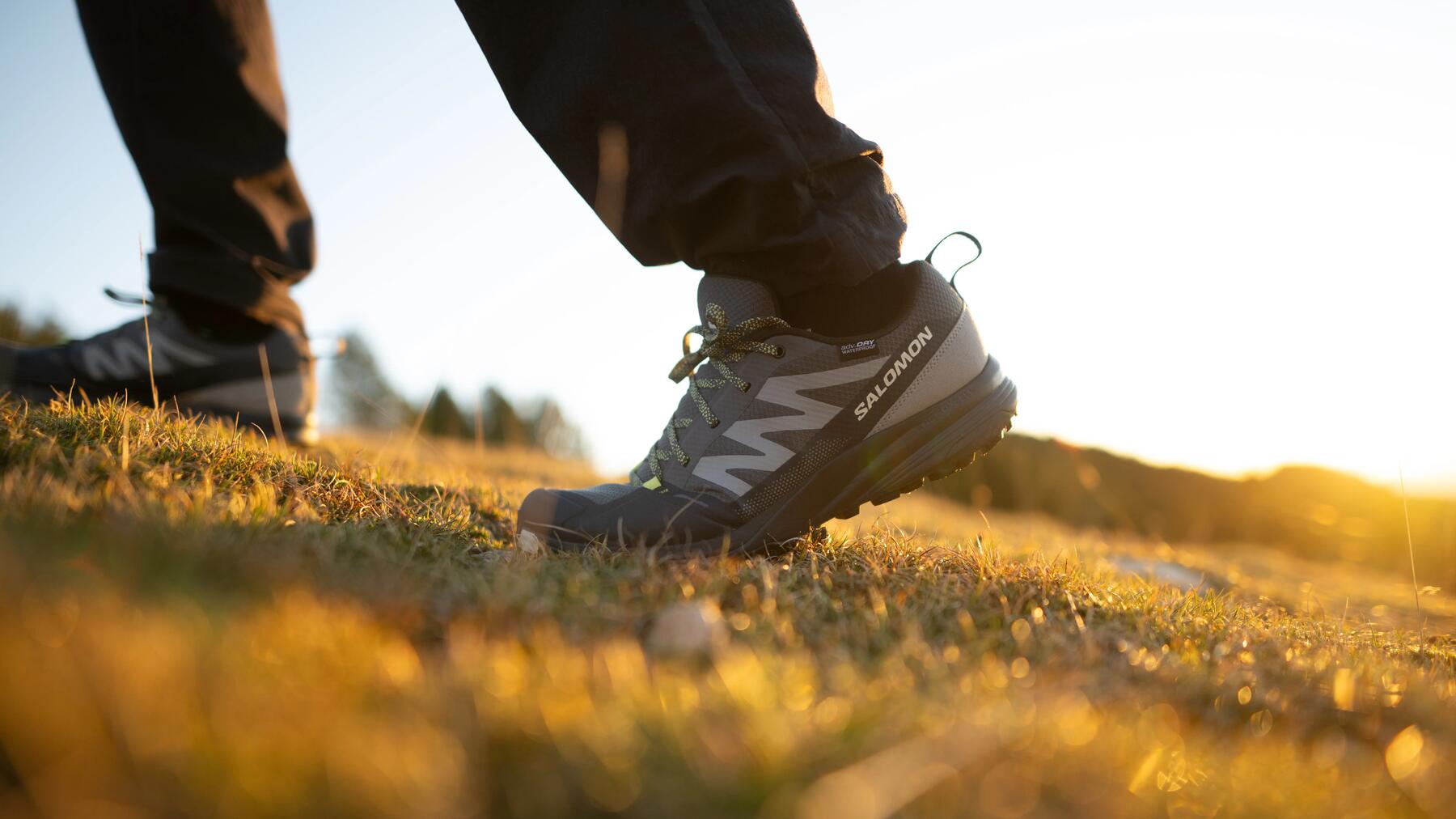couple walking in the mountains with a sunset