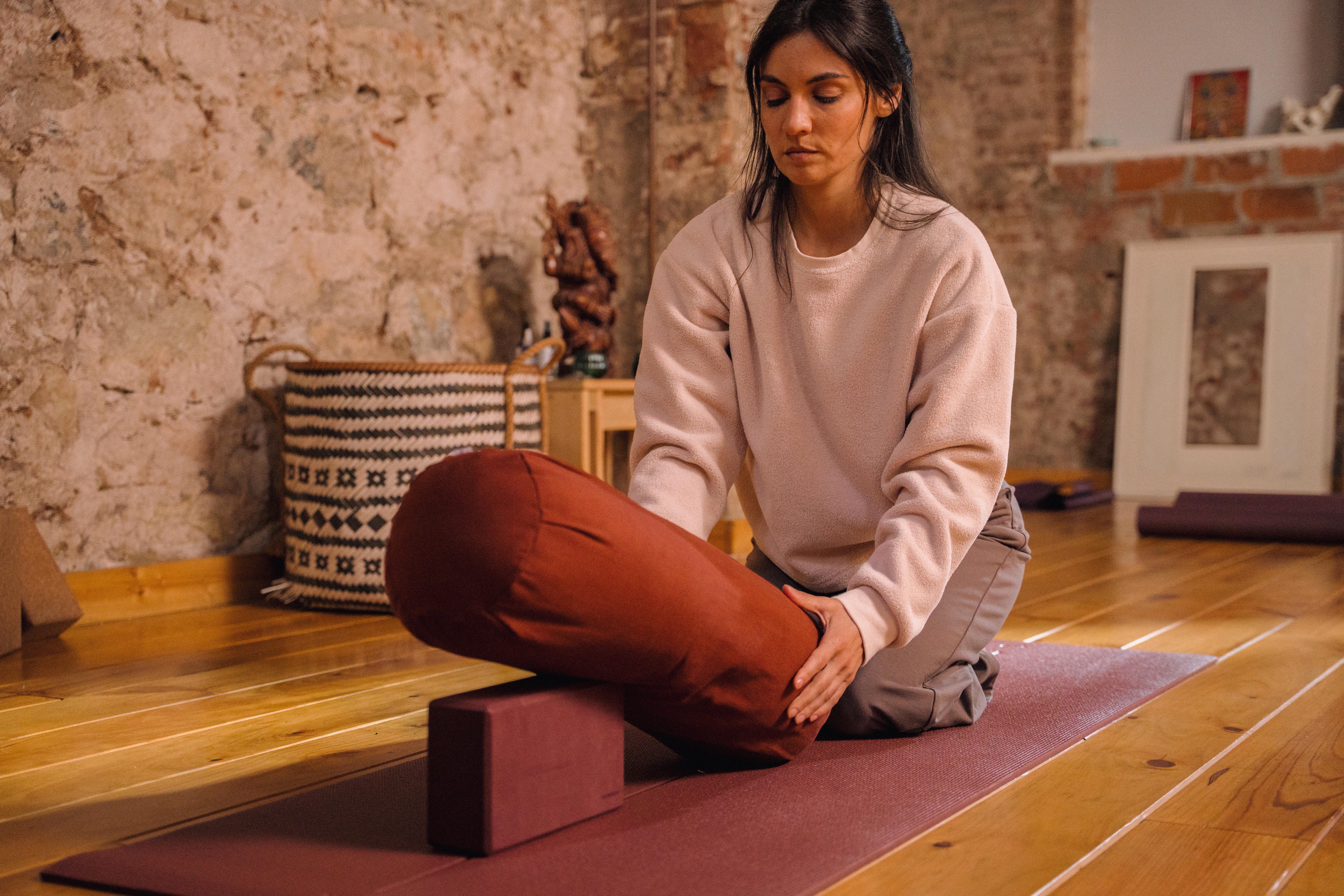 Woman preparing yoga props for practice