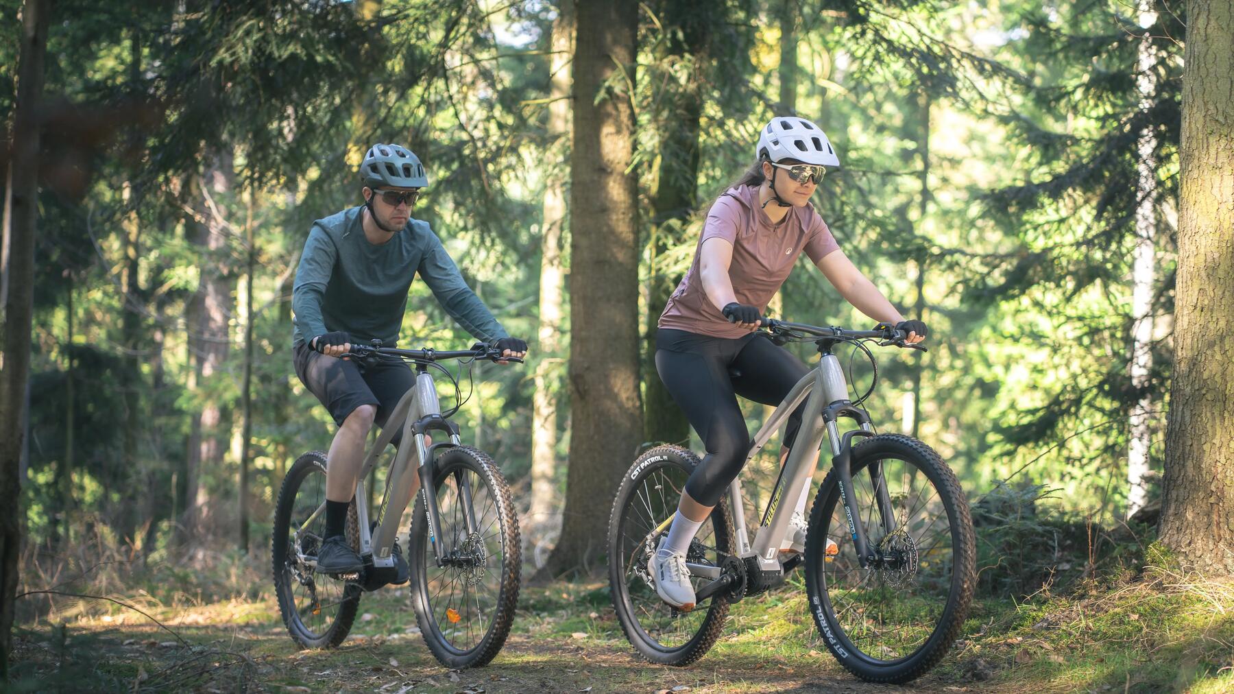 Ein Paar fährt mit Fahrrädern durch den Wald
