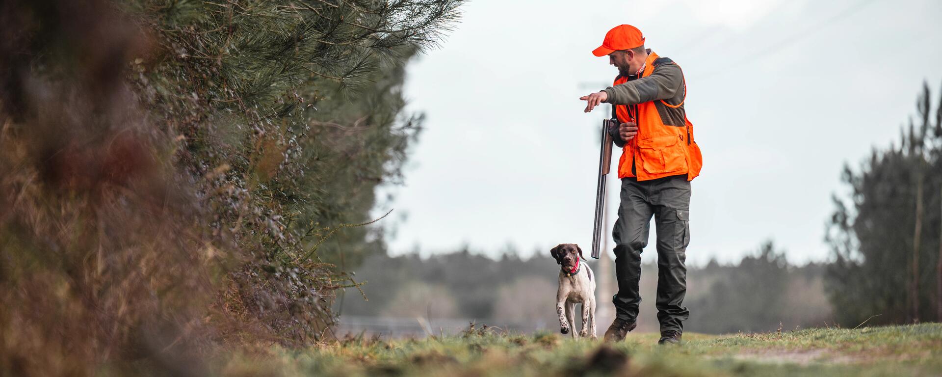 a hunter and their dog on a trail