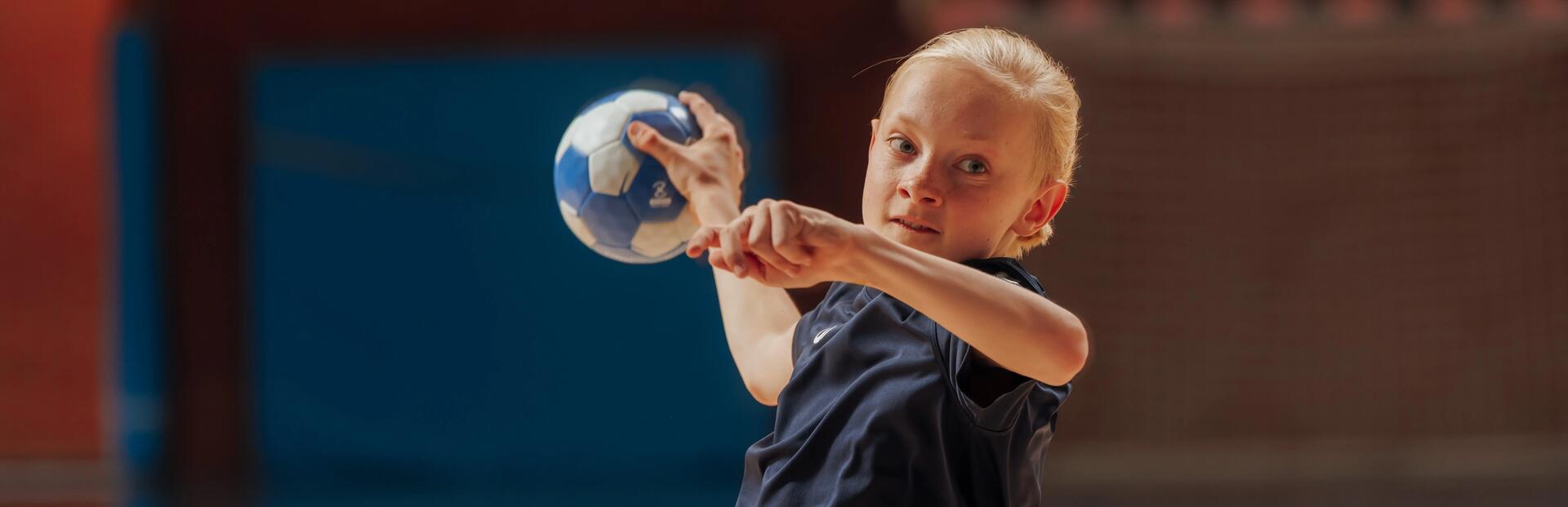 criança a rematar bola de Andebol