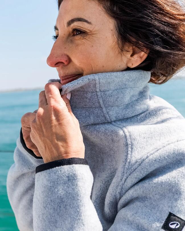 woman turning up the collar of her grey fleece