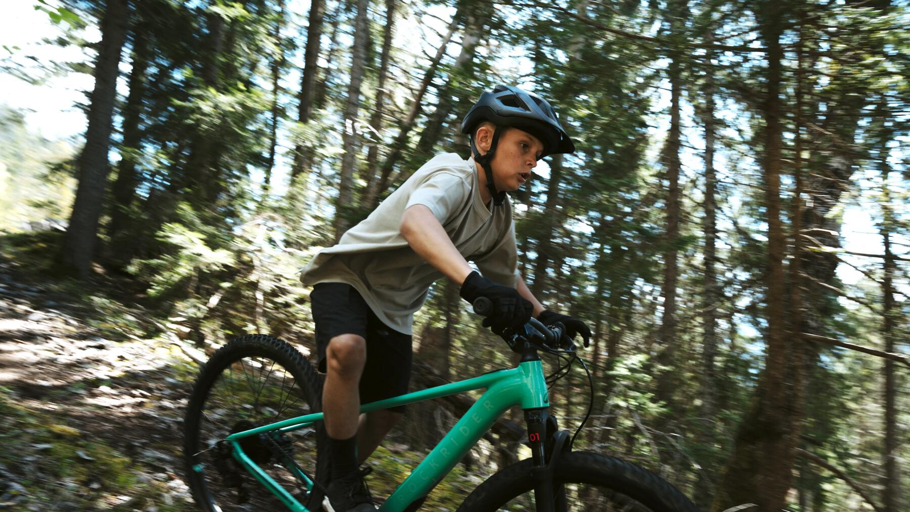 man climbing a hill on his bike