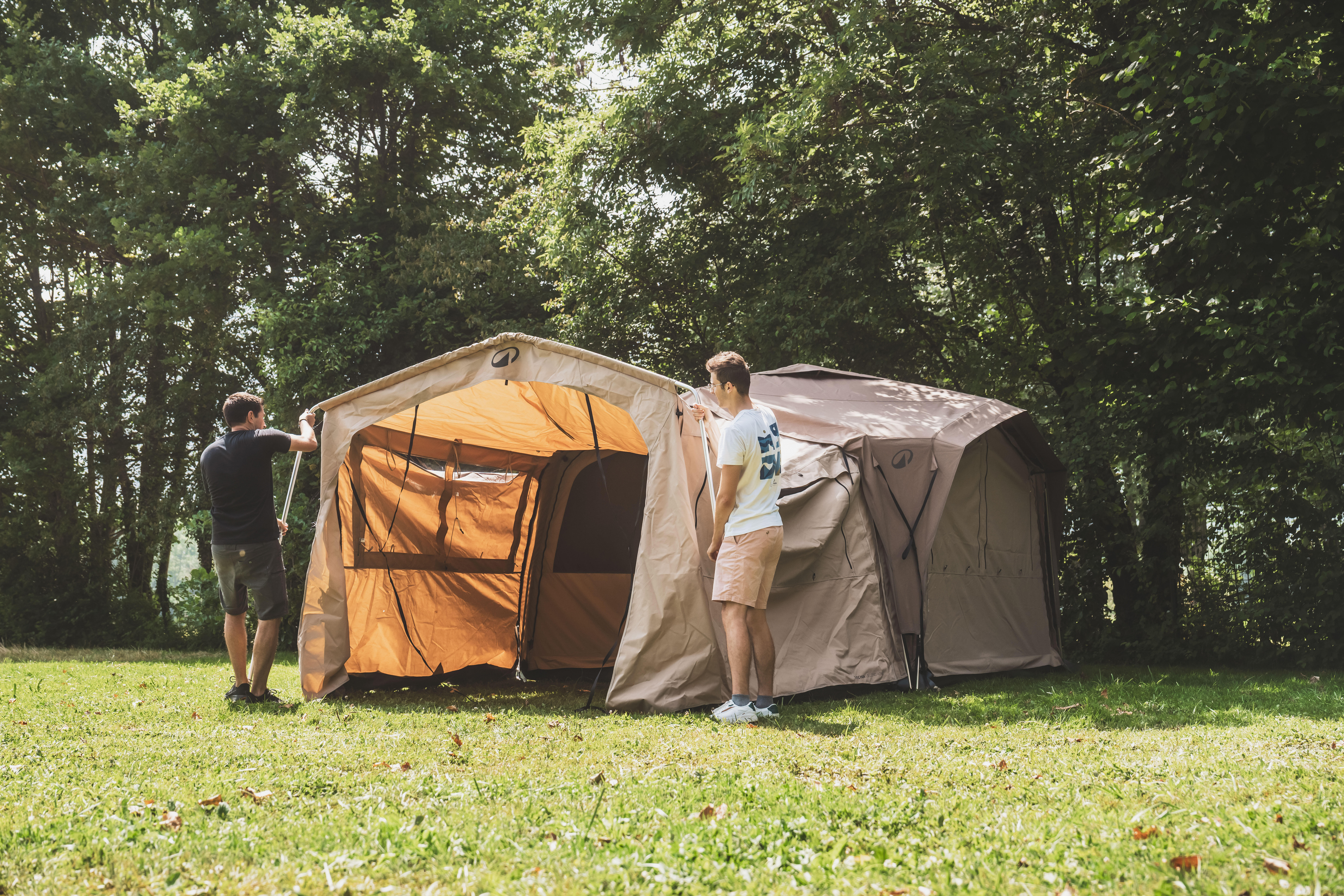 Friends setting up a camping tent outdoors