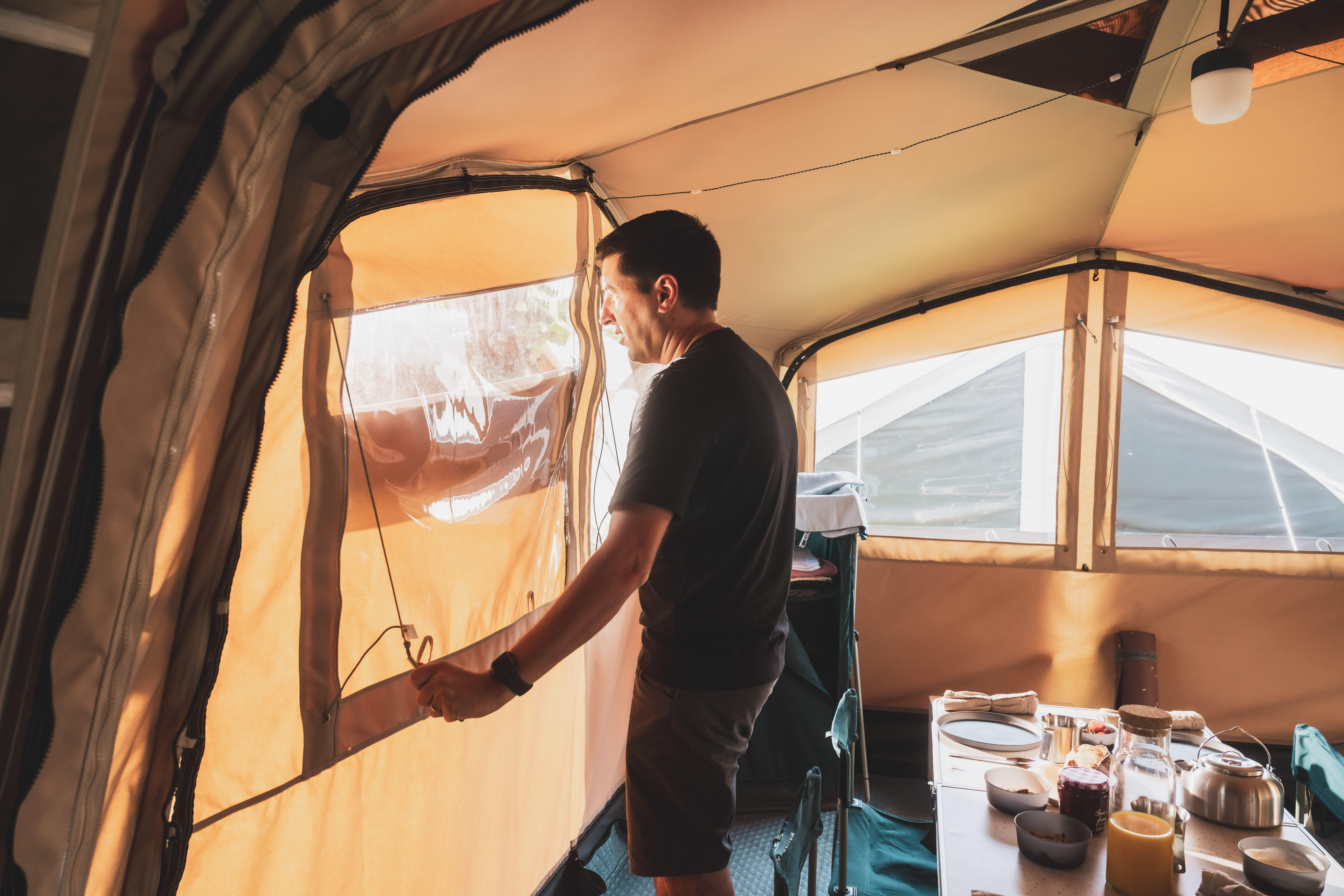 Man relaxing inside a camping tent