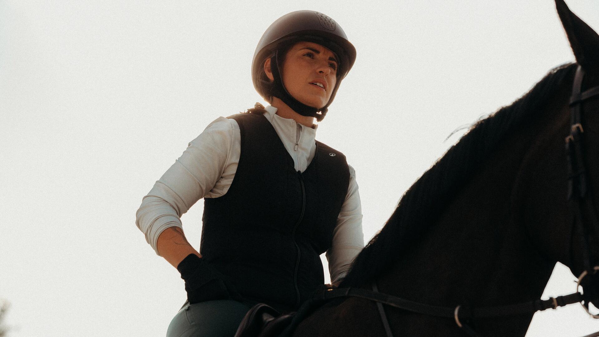 woman adjusting her riding helmet