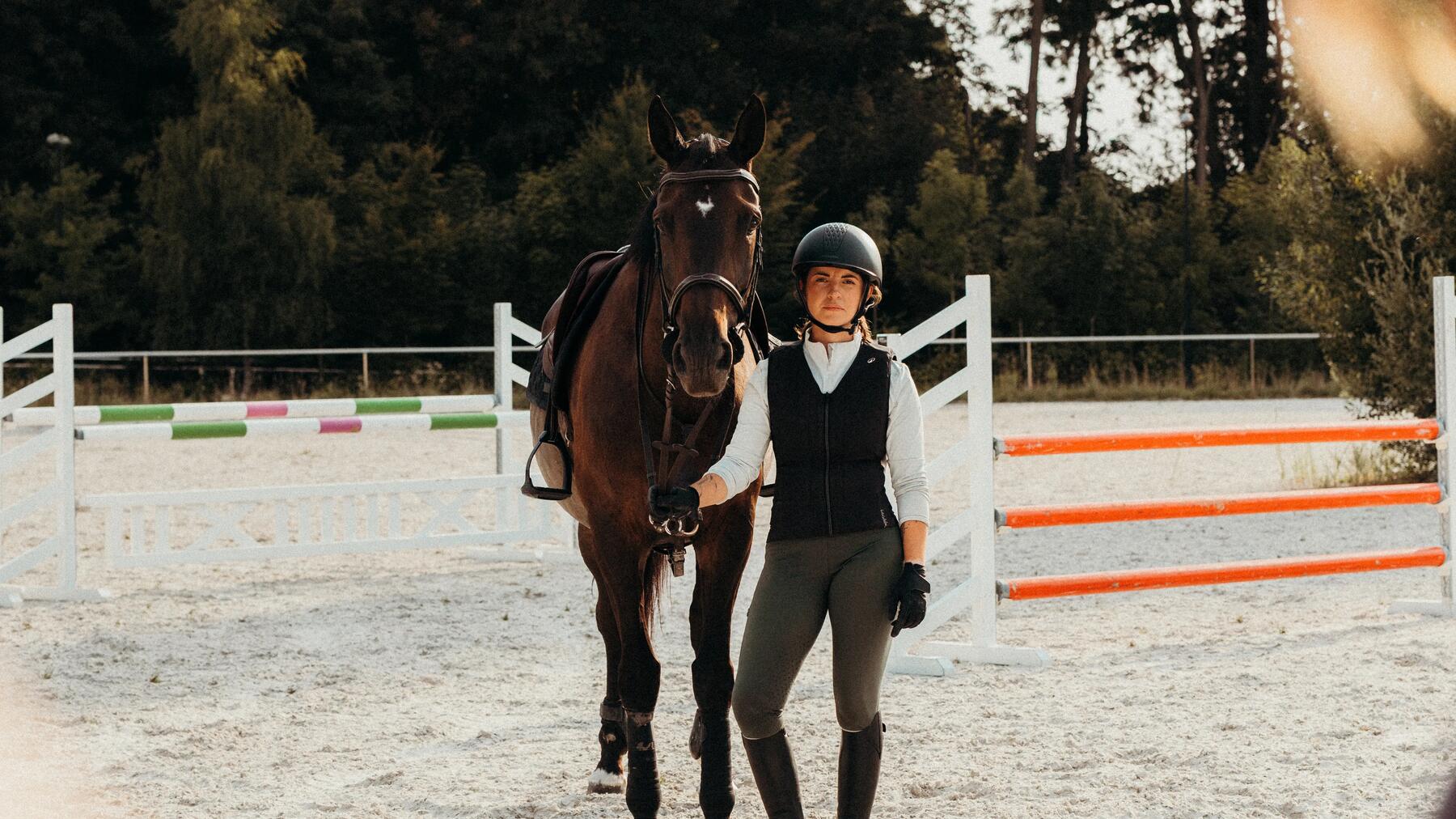 woman wearing riding pants while horseback riding