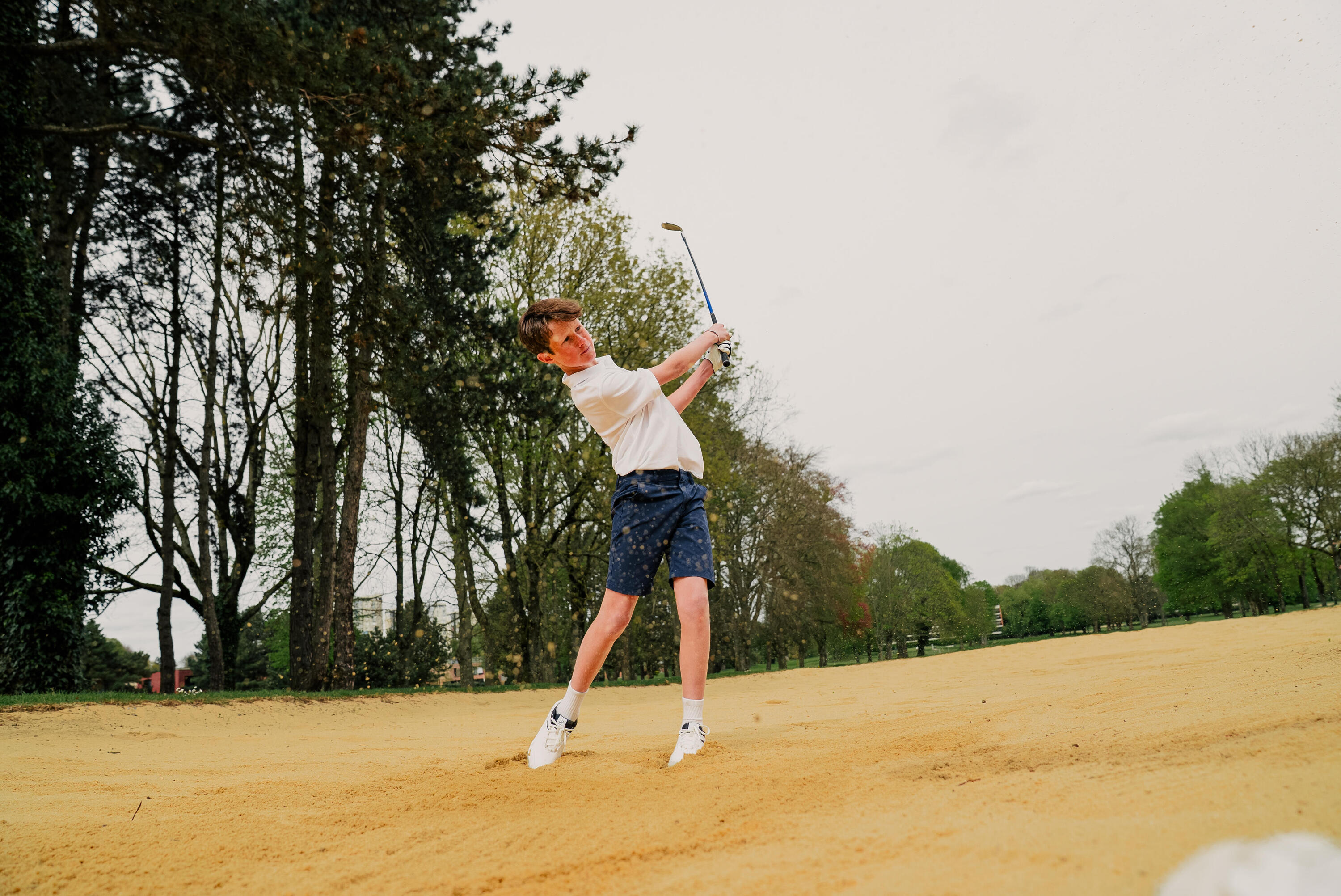Un jeune homme qui tire depuis le bunker de fairway