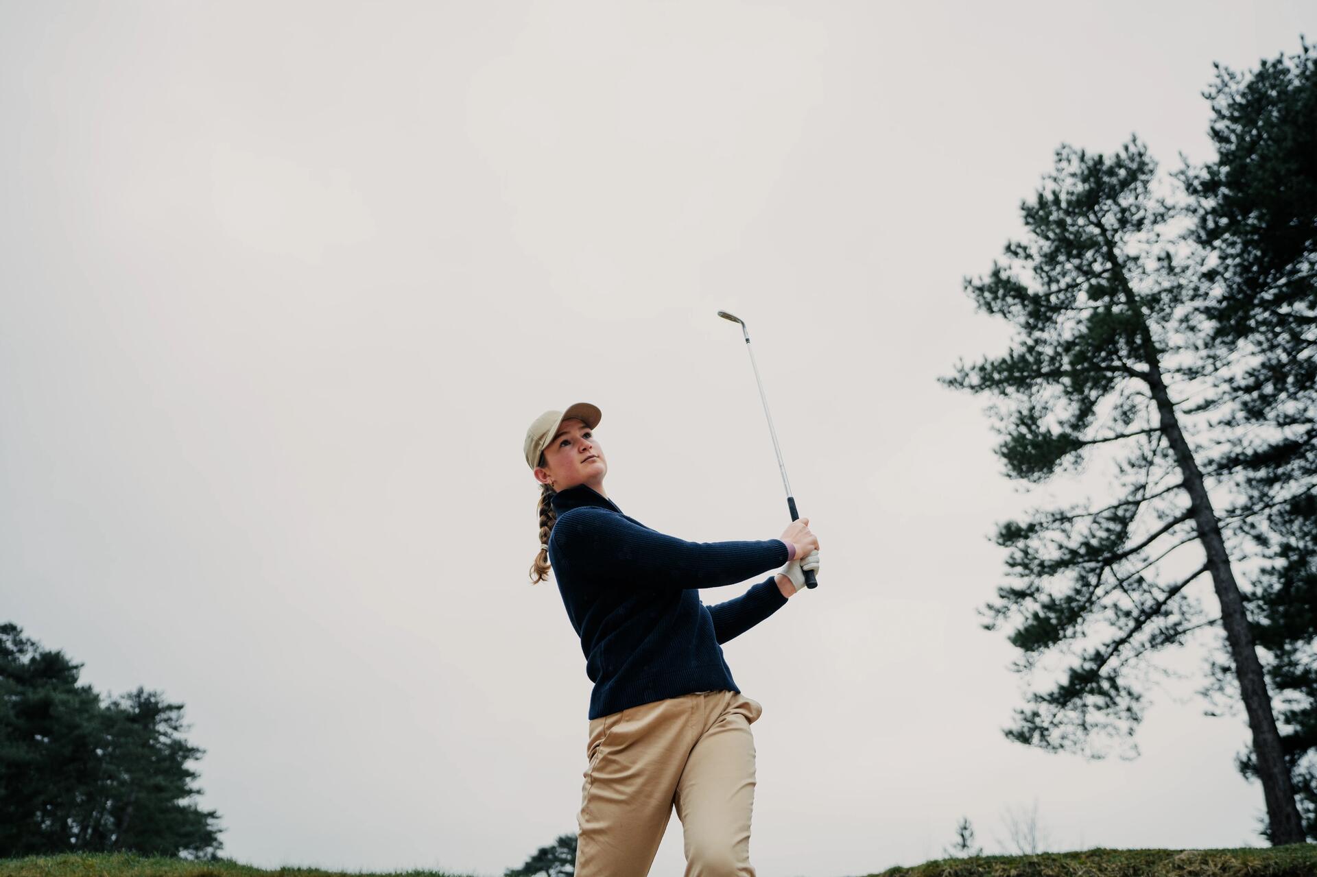 Kobieta wykonująca zamach kijem golfowym