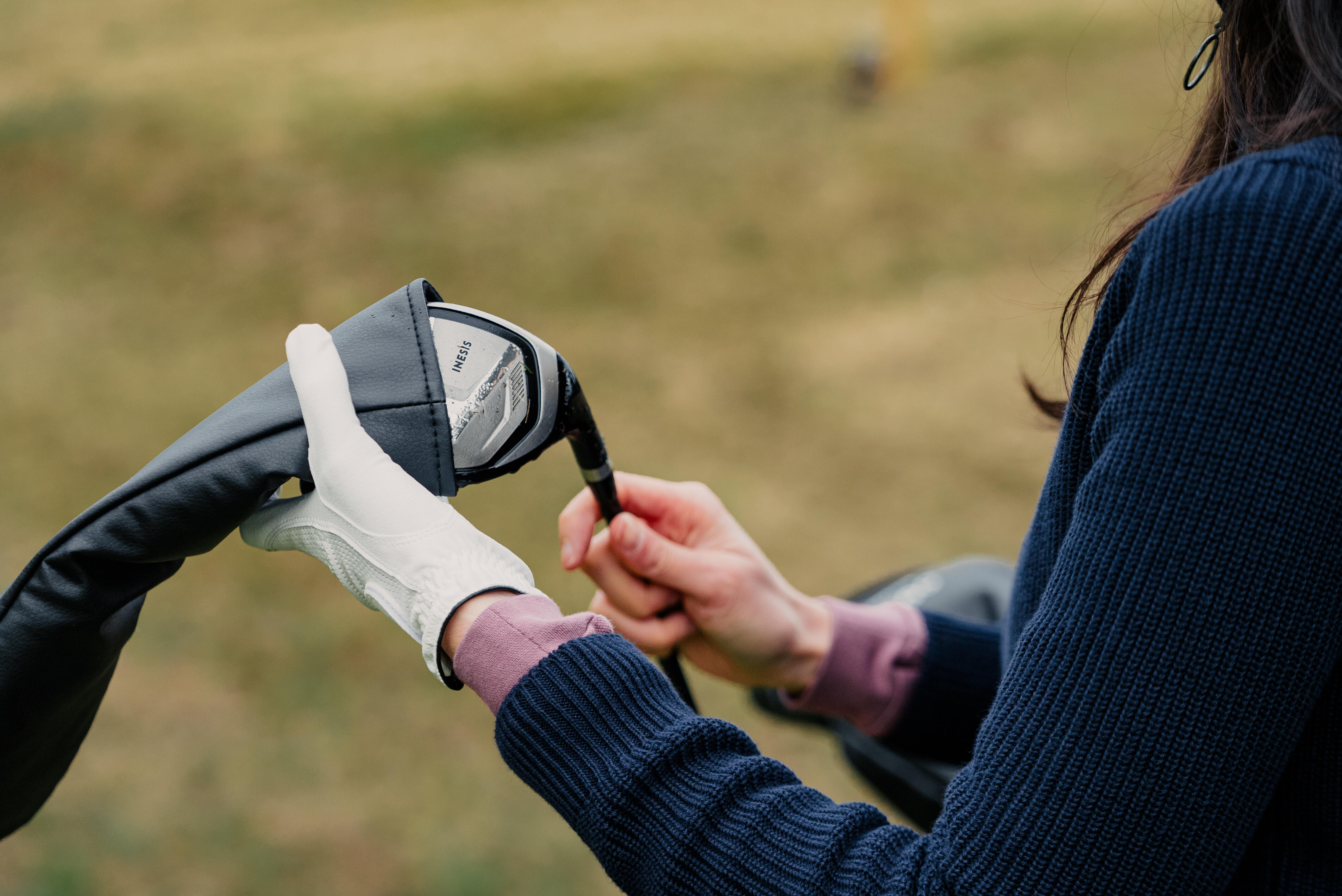 White glove gripping club head, second hand steadying grip nearby
