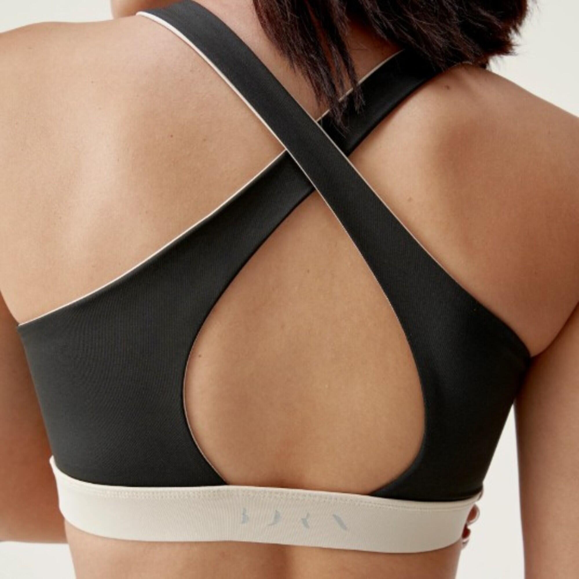 Top deportivo sujeción media reversible Mujer Born living yoga Fiorella negro. 2/7