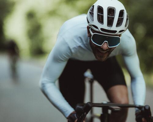 women cycling along fields
