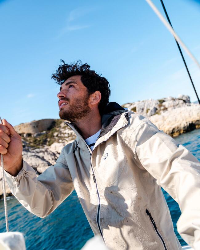 sailor wearing a light rain jacket, on a boat