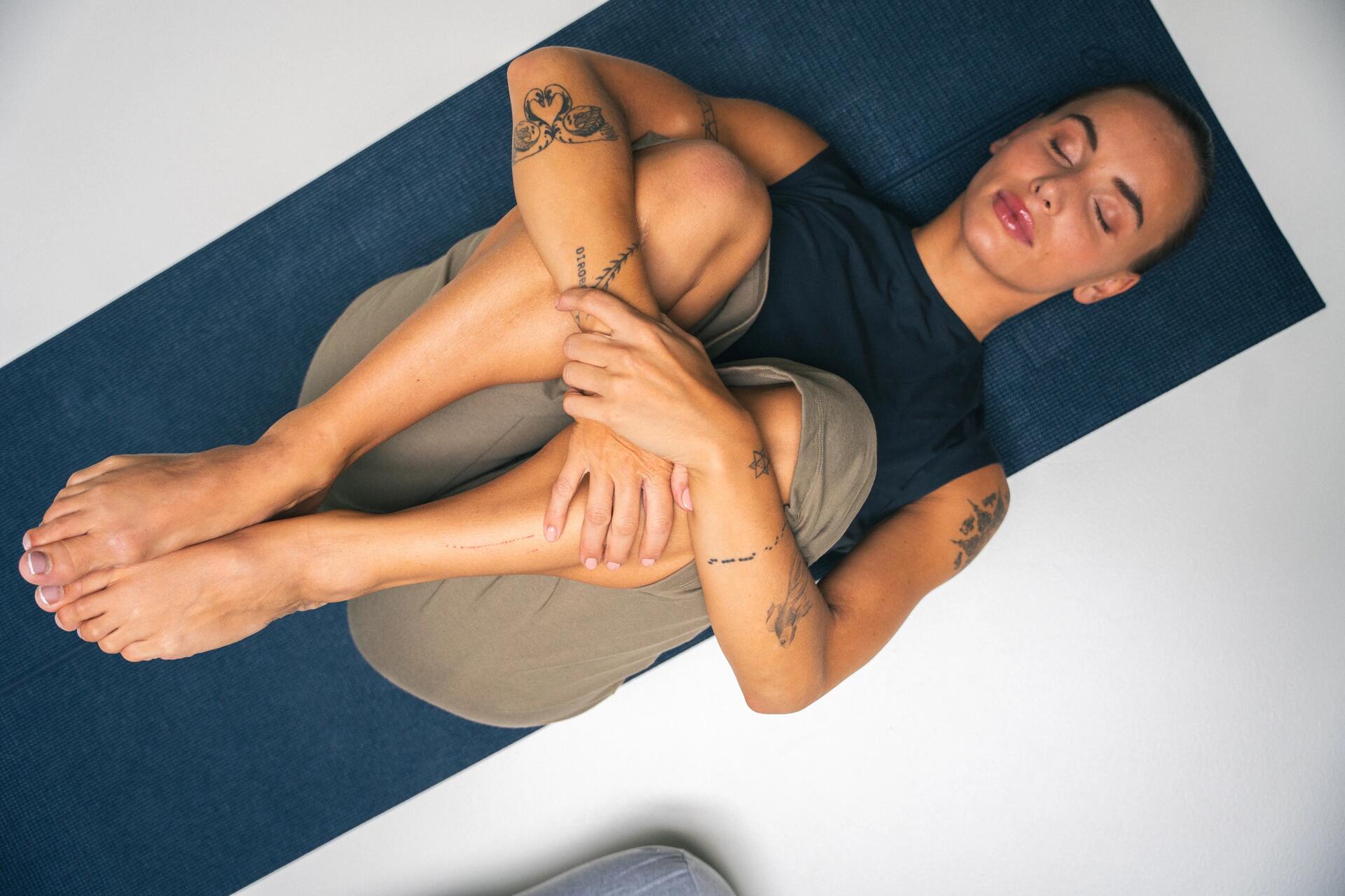 woman doing Pilates at home on her mat