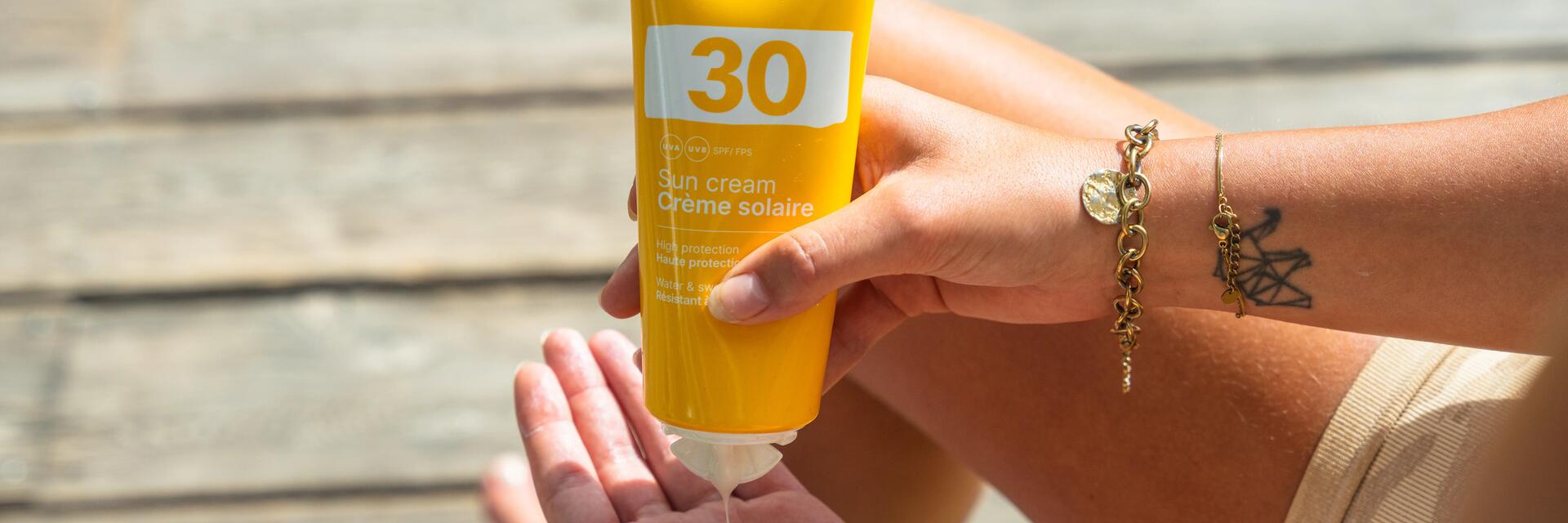 Woman applying sun cream