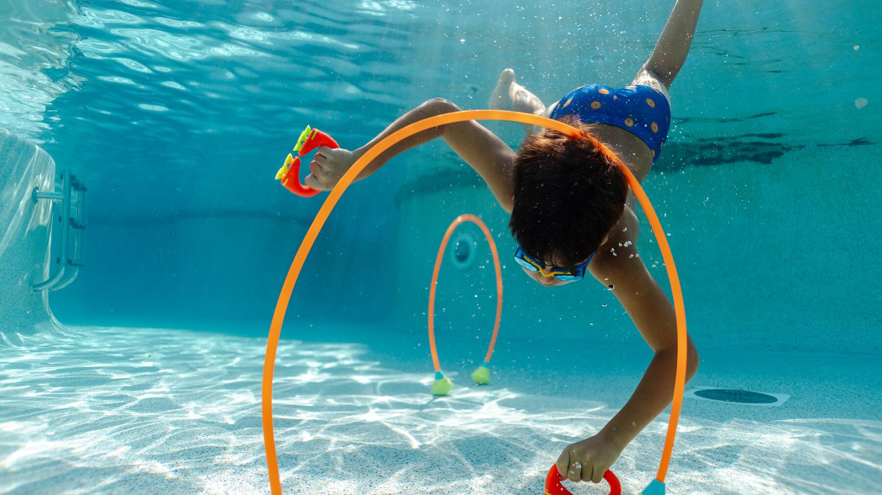 baby learning to use his arms in the pool with mom