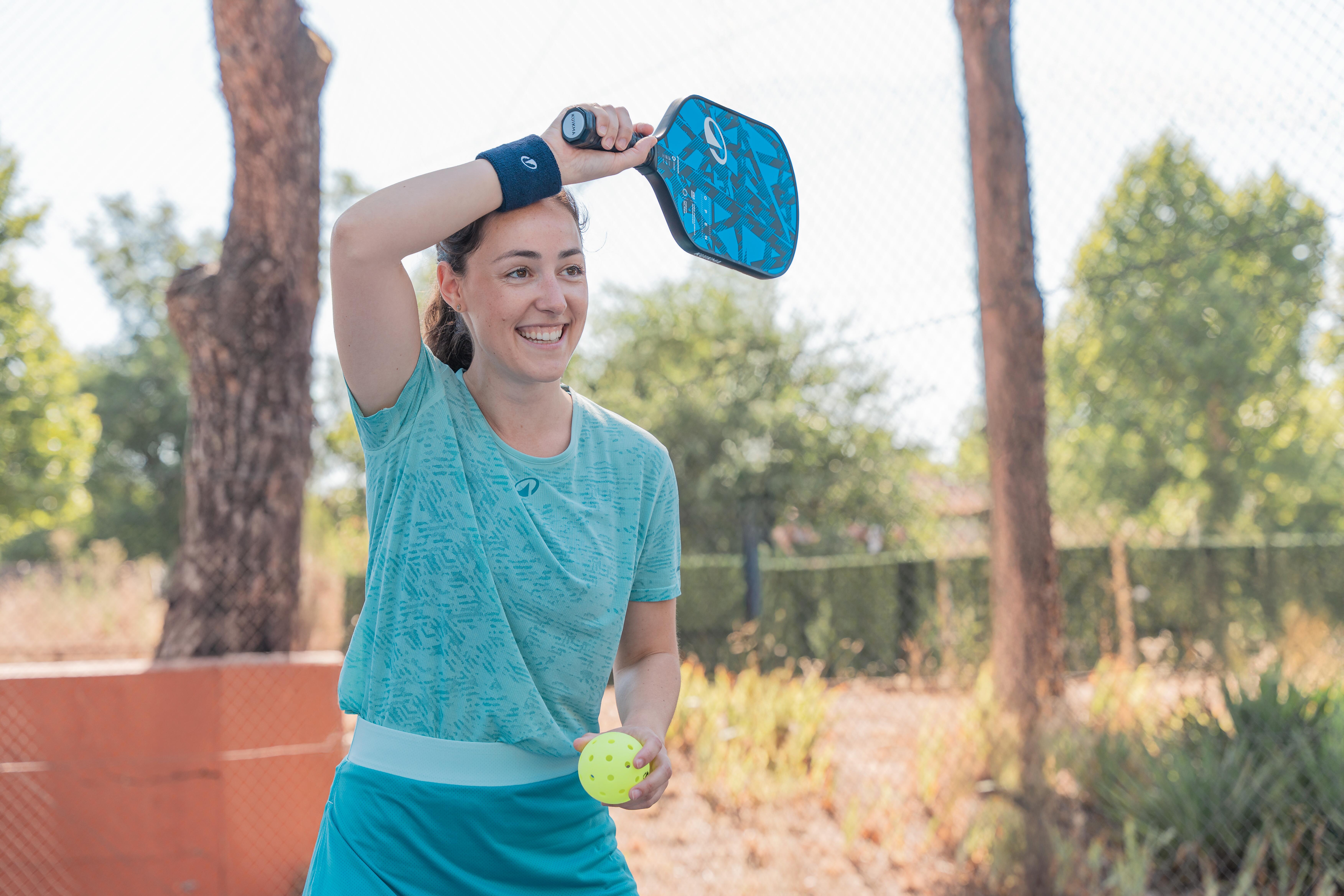 Woman playing pickleball outdoors