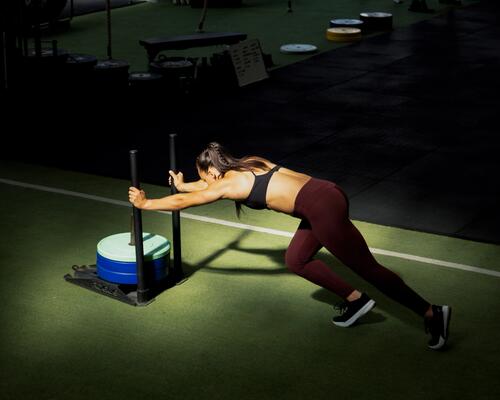 woman doing chin ups with weighted vest