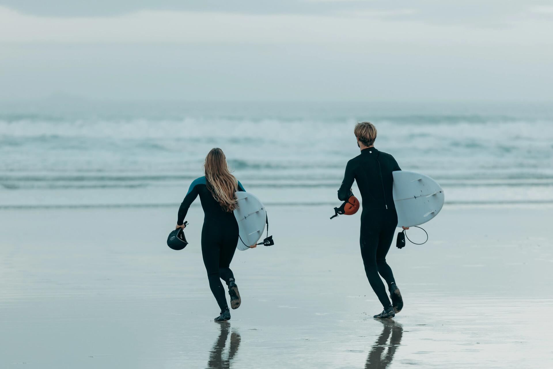 woman swimming with a surf board