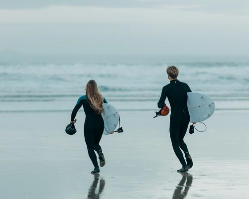 woman swimming with a surf board
