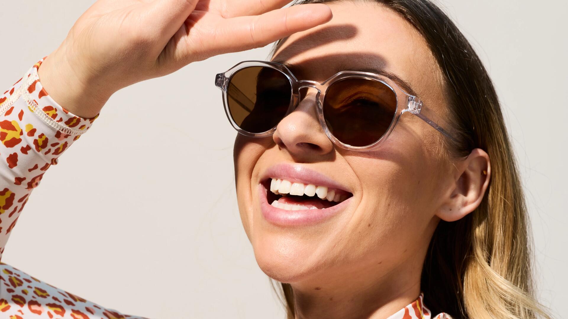 Woman shading her face from the sun with her hand