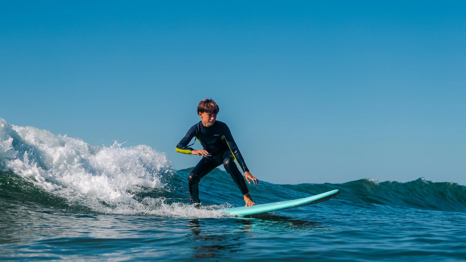 Chlopiec surfujący nad morzem