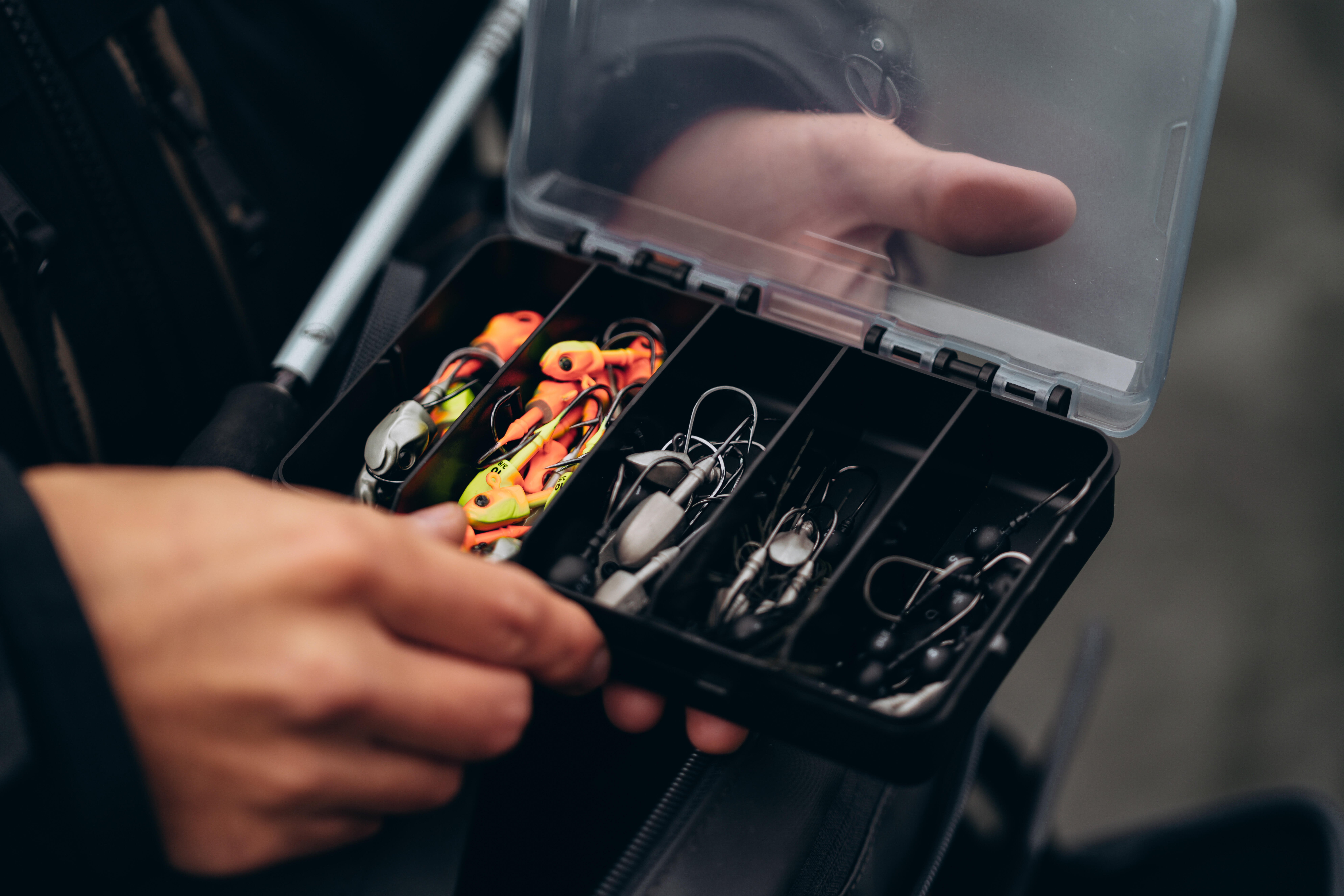 Fishing tackle box organised with hooks and jig heads