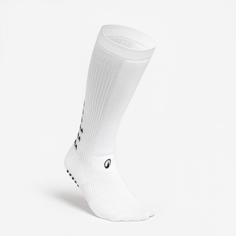 White mid-length football socks with non-slip grip zones on the soles