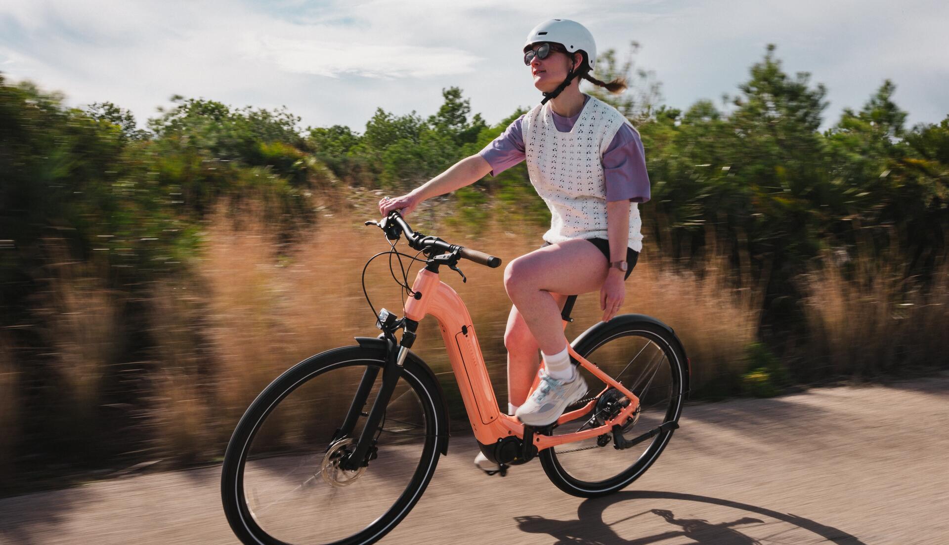 Mulher a andar de bicicleta elétrica na cidade