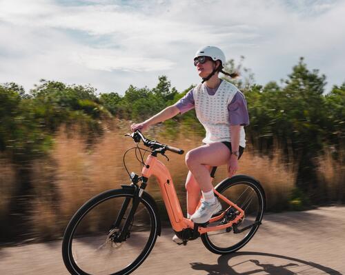 Mulher a andar de bicicleta elétrica na cidade