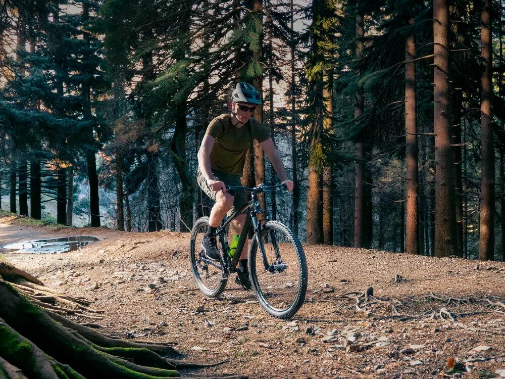 A close up shot of a side profile of a cyclist holding his handlebars