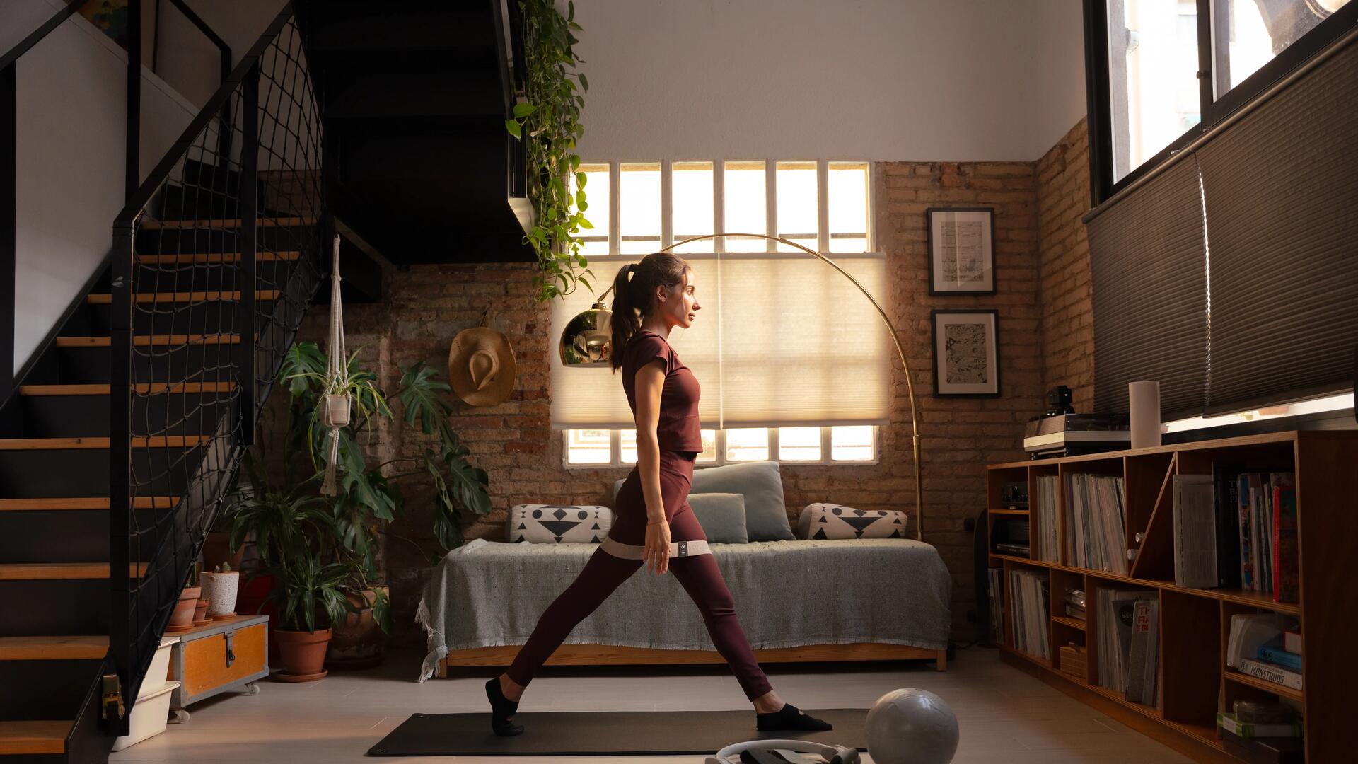 Kobieta w odzieży do pilatesu wykonująca ćwiczenia pilates w domu