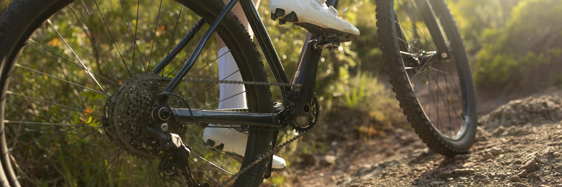 Een close-up van een derailleur van iemand die op een fiets zit
