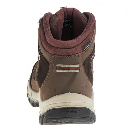 Women’s brown Forclaz 100 High waterproof hiking boots. 
